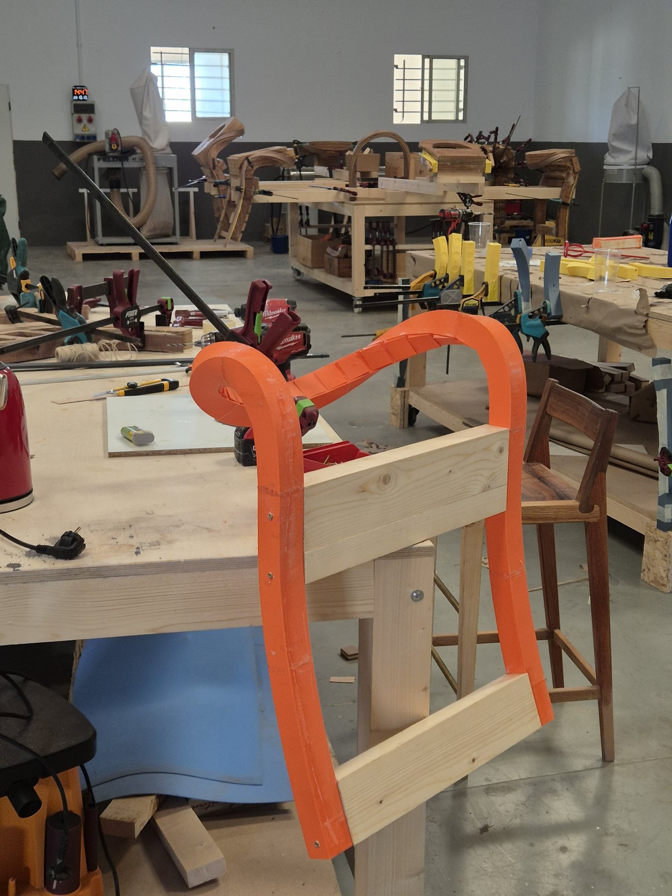Orange 3D-printed bending form in the workshop