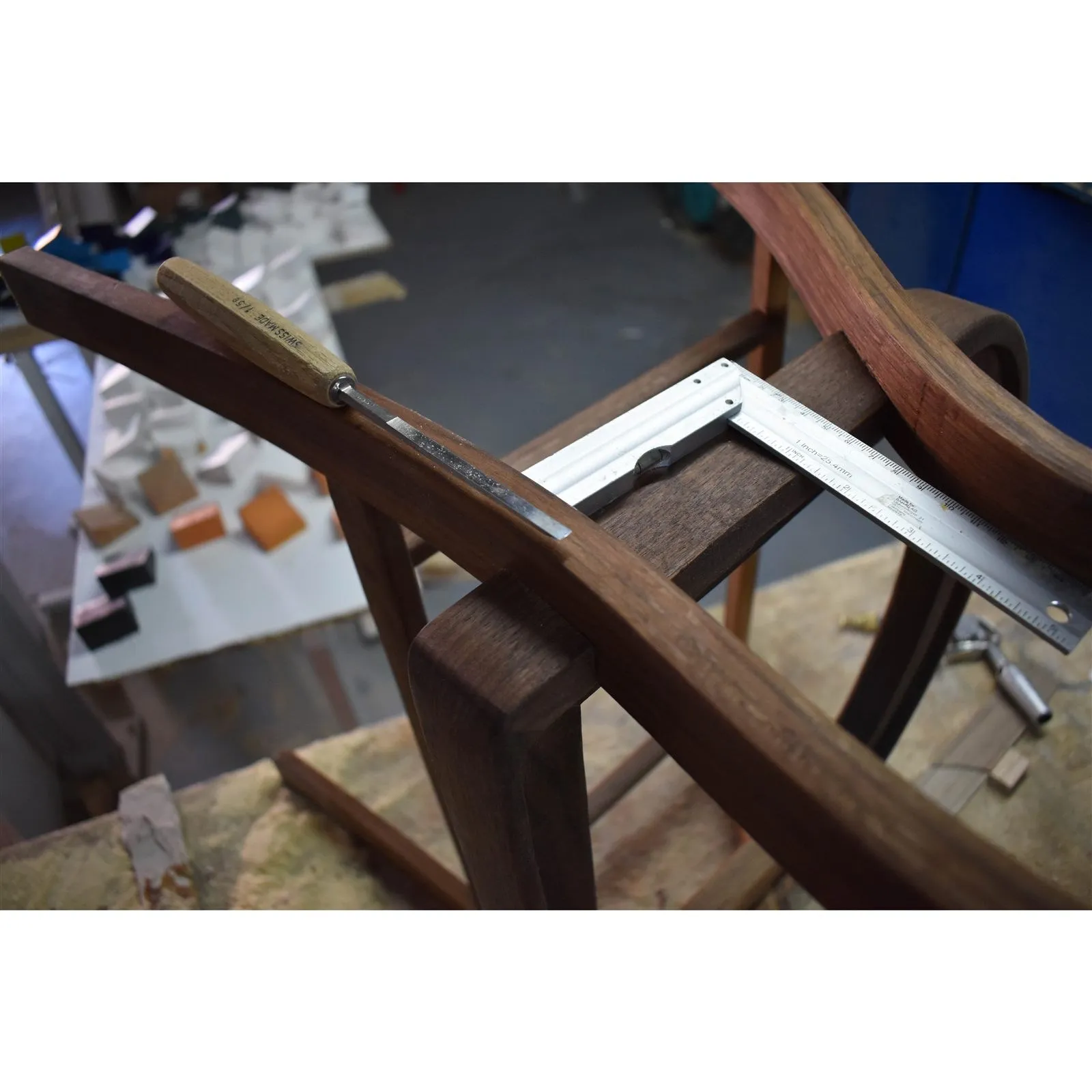 A steam-bent part checked on a jig with a square