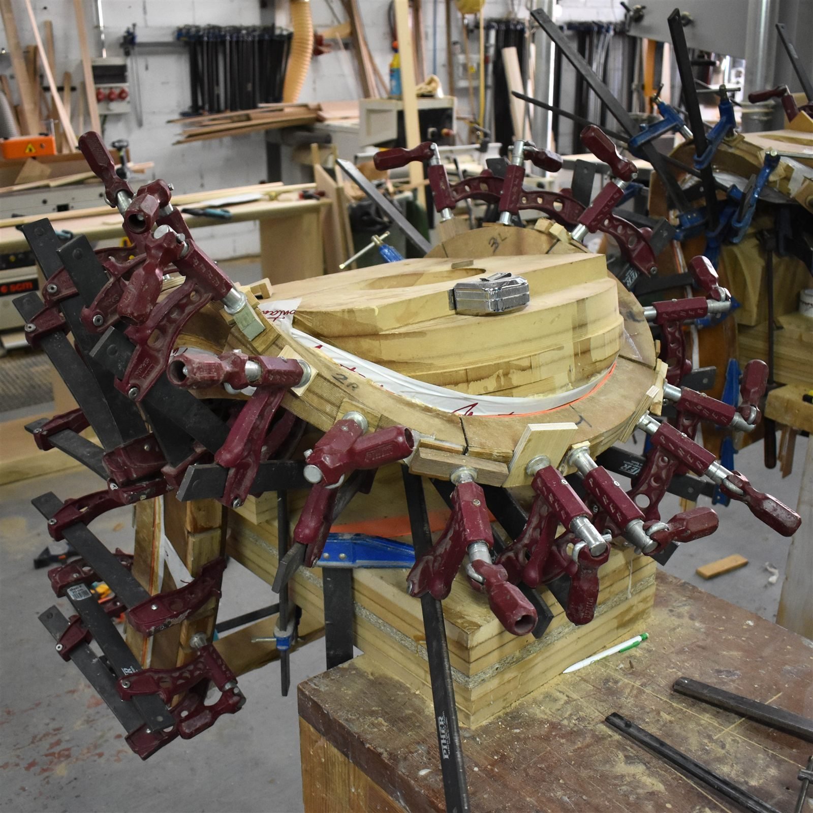 Steam-bent laminations clamped around a form